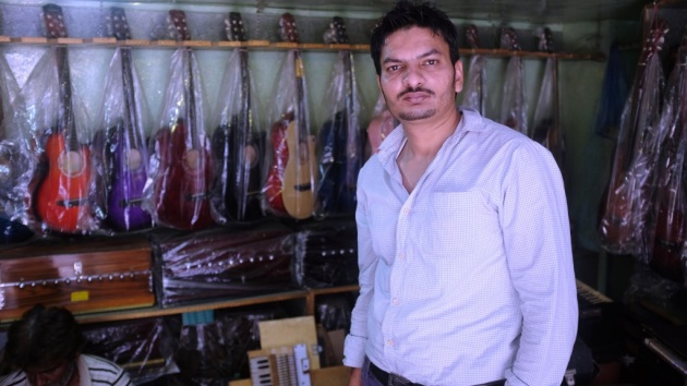 1 - Waqar poses in front of his shop